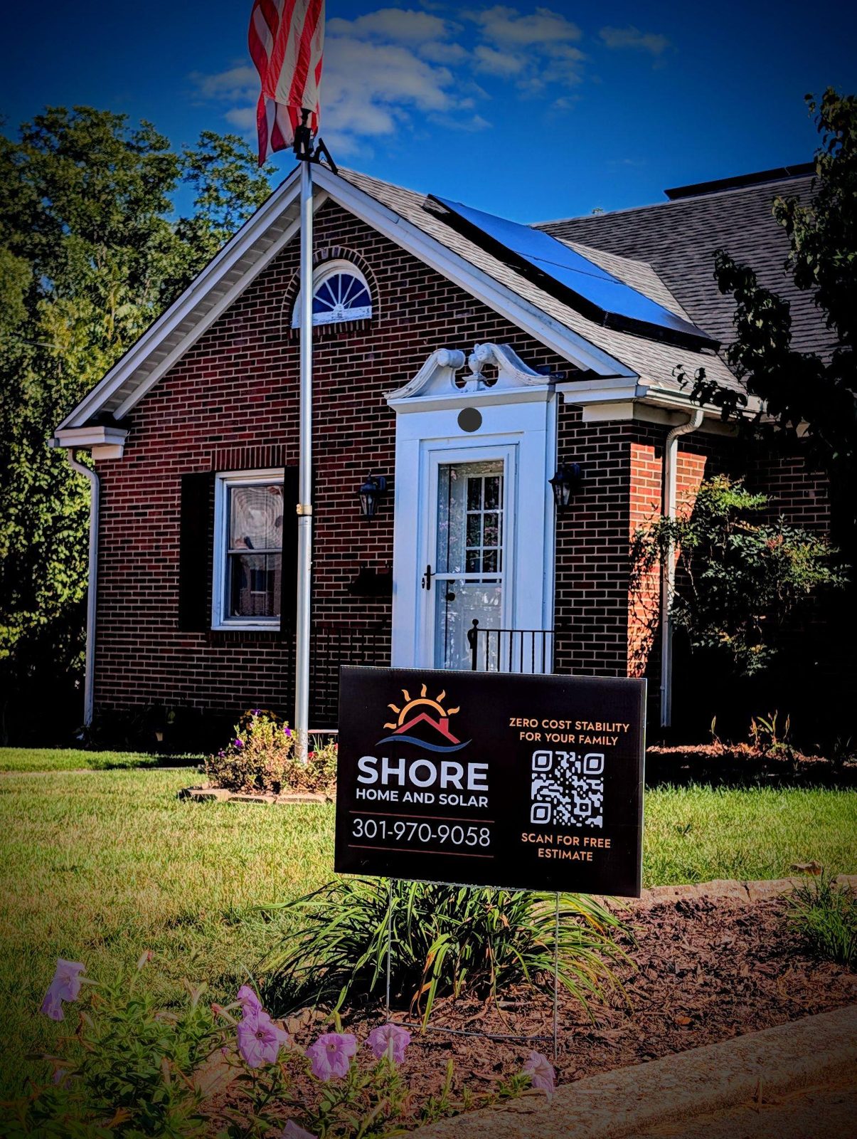 The same Federalsburg home with its finished all-black solar system and Shore Home and Solar yard sign
